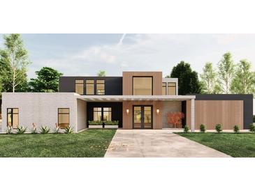Modern home featuring a stylish mix of white brick, black, and wood paneling, enhancing its curb appeal at 104 Accolade Pkwy, Mcdonough, GA 30252