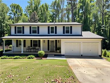 Charming two-story home with a covered front porch, two-car garage, and well-maintained lawn at 2691 Old South Dr, Jonesboro, GA 30236