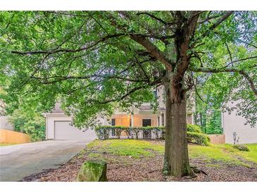 Traditional home with a lush front yard and mature trees providing ample shade at 2341 Alden, Jonesboro, GA 30236