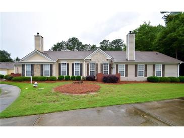 Charming single-story home with well-manicured lawn and mature landscaping creates great curb appeal at 179 Camry Ln, Grayson, GA 30017