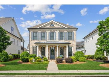 Charming brick home featuring a manicured lawn and a welcoming front porch with elegant columns at 4155 Brookview Dr, Cumming, GA 30040
