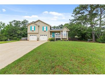 Charming two-story home with a well-manicured lawn, two-car garage, and welcoming front porch at 5 White Pines Dr, Dallas, GA 30157