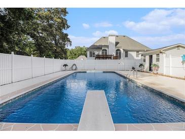 Backyard pool with diving board and white fence at 108 Faraday Dr, Douglasville, GA 30134