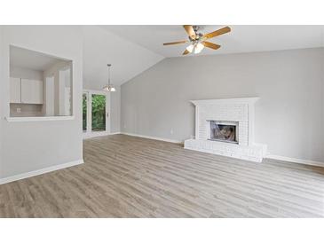 Bright living room with wood floors, fireplace, and sliding glass doors to the outside at 2426 Corner Shoals Dr, Decatur, GA 30034