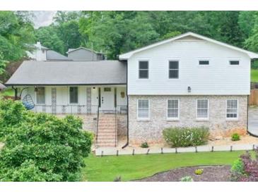 Charming home featuring a combination of brick and siding exterior, complemented by a landscaped front yard and inviting entrance at 281 Lakeshore Ne Dr, Marietta, GA 30067