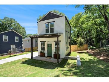 Charming two-story home with a modern design and a well-manicured lawn at 1473 Lansing Se St, Atlanta, GA 30315