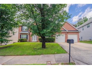 Charming brick home with well-manicured lawn and two-car garage at 7190 Cavender Sw Dr, Atlanta, GA 30331