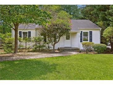 Charming one-story home featuring a well-maintained lawn and a quaint walkway leading to the front door at 1891 8Th St, Atlanta, GA 30341