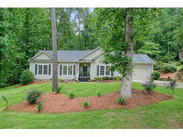 Charming single-story home with manicured front lawn, mature trees, and welcoming curb appeal at 3286 Crawford Cir, Marietta, GA 30066