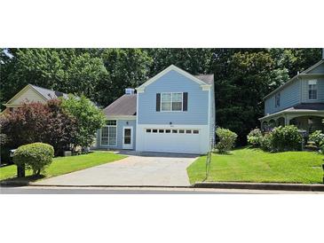 Charming two-story home with a well-maintained lawn and attached two-car garage at 4965 N Bridges Dr, Alpharetta, GA 30022
