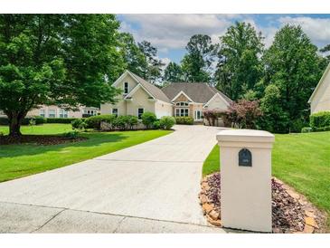 Well-maintained one story home boasting lush landscaping, a long driveway, and craftsman architectural details at 1275 Kelly Nelson Dr, Lawrenceville, GA 30043