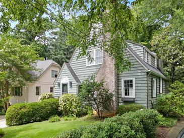 Charming home with a brick chimney and lots of surrounding mature landscaping at 2054 Palifox Ne Dr, Atlanta, GA 30307