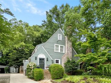 Charming exterior view of home with a stone walkway leading to the front door, framed by lush greenery at 2054 Palifox Ne Dr, Atlanta, GA 30307
