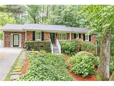 Charming brick home with mature landscaping, black shutters, and a welcoming front porch at 2197 Fairway Ne Cir, Brookhaven, GA 30319