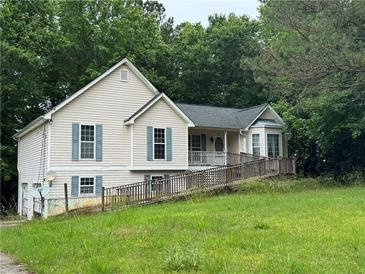 Charming home featuring light siding, light shutters, lush greenery, and a convenient ramp to the front door at 134 Summer Lake Dr, Dallas, GA 30157
