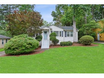 Charming home with a well-manicured lawn, inviting entryway, and lush landscaping at 1680 Bristol Ne Dr, Atlanta, GA 30329