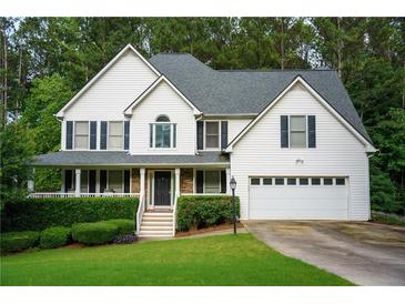 Charming two-story home with a well-manicured lawn and attached two car garage at 111 Bexley Ln, Douglasville, GA 30134