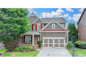 Charming two-story home with well-manicured lawn, colorful flowerbeds, and a two-car garage at 4495 Hedgewood Dr, Cumming, GA 30041