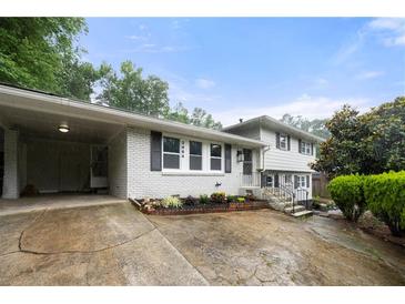 Charming split-level home featuring a well-manicured front yard and a convenient carport at 3664 Pin Oak Cir, Atlanta, GA 30340