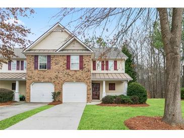 Charming townhome with brick and siding, complemented by a well-manicured lawn at 184 Darbys Crossing Ct, Hiram, GA 30141