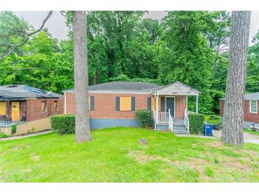 Charming single-story brick home with a front porch and landscaped yard at 2817 Burton Nw Rd, Atlanta, GA 30311