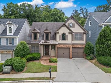 Charming home featuring two-car garage, manicured lawn and inviting front entrance at 3725 Paces Park Se Cir, Smyrna, GA 30080