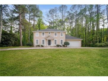 Charming two-story home with a well-manicured lawn and attached two-car garage at 2799 Lake Jodeco Rd, Jonesboro, GA 30236