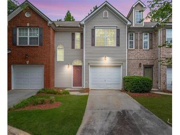 Charming two-story home with a well-manicured lawn, attached garage, and inviting front entrance at 780 Nehemiah Sw Ln, Atlanta, GA 30331