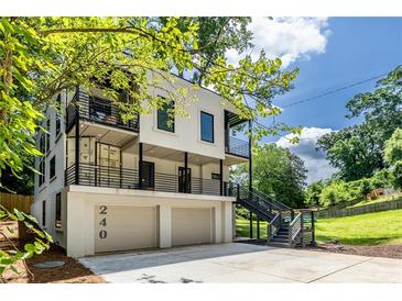 Modern, multi-level home featuring balconies, a two-car garage, and unique architectural details at 240 Patterson Se Ave, Atlanta, GA 30316