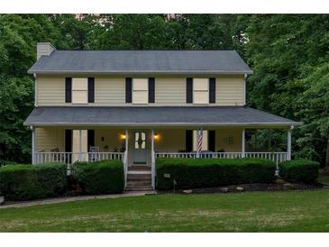 Charming two-story home with a welcoming front porch and manicured landscaping for curb appeal at 40 Picketts Forge W Dr, Acworth, GA 30101
