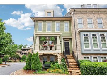 Charming two-story home featuring a quaint porch with a garden and a brick-lined walkway up to the front door at 4588 Pine Se St, Smyrna, GA 30080