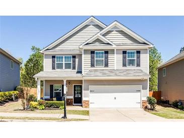 Charming two-story home featuring neutral siding, black shutters, and a well-manicured front lawn at 327 Nobleman Way, Canton, GA 30114
