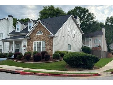 Beautiful exterior view showcasing stone accents, well-maintained landscaping, and a cozy suburban setting at 636 Lantern Park Ln, Scottdale, GA 30079