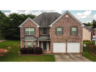 Charming brick two-story home with a two-car garage and well-maintained front lawn at 4676 Shaded Oak Ln, Forest Park, GA 30297