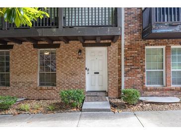Charming brick townhome featuring a clean white front door and well-maintained landscaping for inviting curb appeal at 7307 Cardigan Cir, Sandy Springs, GA 30328