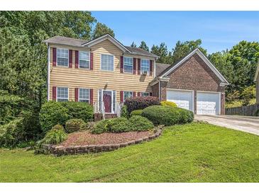 Charming two-story home featuring a landscaped yard and a two-car garage, perfect for Gathering living at 474 Boxelder Rd, Atlanta, GA 30349