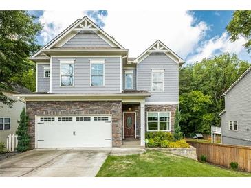 Beautiful two-story home featuring stone accents and a well-manicured lawn at 2573 Paul Nw Ave, Atlanta, GA 30318