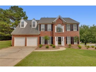 Beautiful brick two-story home with a well-manicured lawn, attached two car garage, and tasteful landscaping at 1942 Westover Nw Ln, Kennesaw, GA 30152