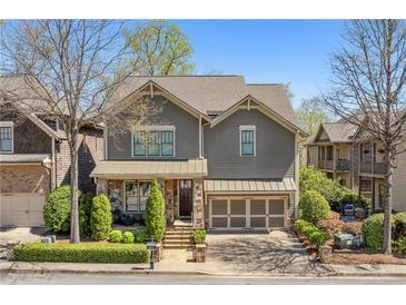 Charming home with stone accents, a well-manicured lawn, and an attached two car garage at 4541 Gateway Se Ct, Smyrna, GA 30080