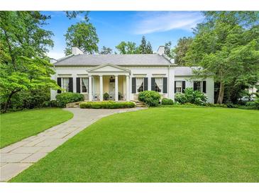 Elegant white home featuring a large lawn, columns, and classic shutters at 2 W Muscogee Nw Ave, Atlanta, GA 30305
