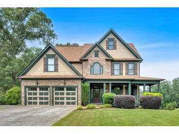 Charming two-story home with a two-car garage, stone accents, and a welcoming front porch at 17 River Walk Pkwy, Euharlee, GA 30145