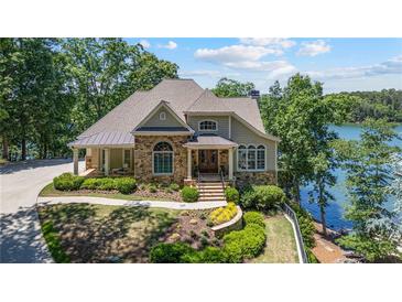 Charming stone and shake home with manicured landscaping and lake view at 7815 Bamby Rd, Cumming, GA 30041