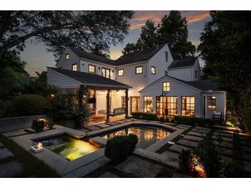 Stunning backyard oasis with a sparkling pool, spa, and lush landscaping, perfect for outdoor entertaining at 820 Highland Ne Ter, Atlanta, GA 30306