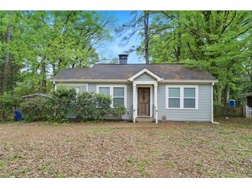 Charming single-story home with gray siding, surrounded by lush trees at 2505 Mellville Ave, Decatur, GA 30032