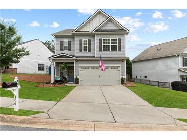 Charming two-story home with manicured lawn, covered entryway, and neutral gray tones at 106 Cessna Dr, Canton, GA 30114