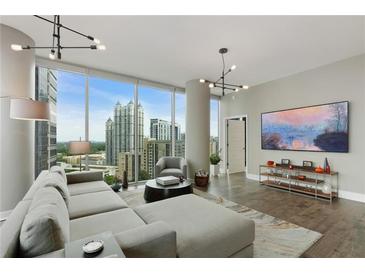 Bright living room featuring expansive windows with city views and stylish contemporary furnishings at 1080 Peachtree Ne St # 1402, Atlanta, GA 30309