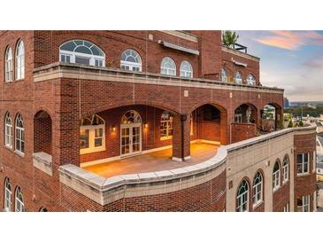 Spacious outdoor patio with brick archways and rooftop access at 3180 Mathieson Ne Dr # 1401, Atlanta, GA 30305