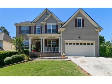 Charming two-story home featuring a well-maintained lawn, two-car garage, and inviting front porch at 829 Castlebottom Dr, Lawrenceville, GA 30045