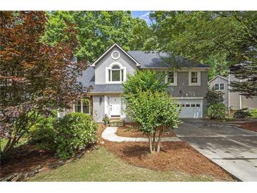 Charming two-story home with a well-manicured lawn and a cozy, inviting curb appeal at 1867 N Creek Cir, Alpharetta, GA 30009