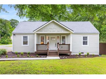Charming single-story home featuring a cozy front porch, fresh landscaping, and inviting curb appeal at 1927 Alexander Se St, Smyrna, GA 30080